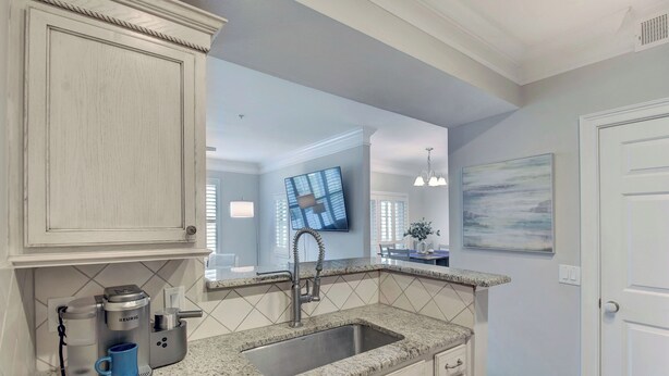 A kitchen with a built-in sink, a coffee maker, and a countertop. - Beautifully Decorated Condo, St. Simons Island, 8 minutes to Beach, Heated Pool (St. Simons Island)