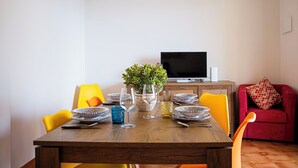 A dining table set with plates, glasses, and a potted plant. - Star Apartment, Alcamo Marina, 3 bedrooms, swimming pool, view and fun... enjoy (Alcamo)