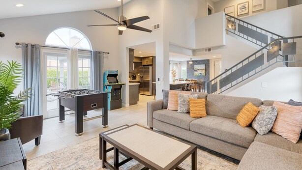A spacious living room with a foosball table, a sofa with cushions, and a coffee table. - Desert Scarif Private Pool Hot Tub Putting Green Near Coachella Festivals (Indio)