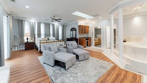 A spacious living area with a large sofa set, a dining table, and a kitchen area. - National Harbor  Hideaway - Oasis /Jacuzzi w/ 4-bedroom/3-Bath  
Fort Washington (Fort Washington)