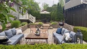 A patio with outdoor furniture, a barbecue grill, and a covered table. - Historic Edge of the River, Adirondacks (Willsboro)