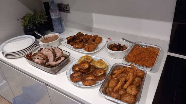 A buffet table with various dishes including meat, fried items, and baked goods. - Room-charming Loughton Apartment With Ba (Loughton)