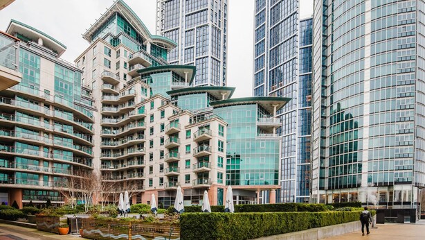 A modern high-rise building with multiple balconies and a glass facade.