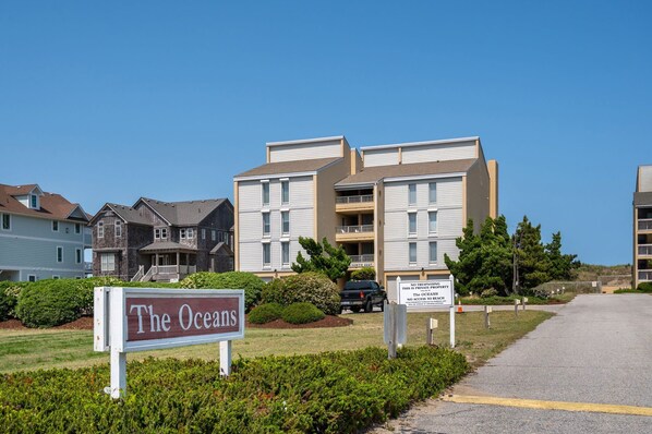 A multi-story residential building with a sign reading "The Oceans."