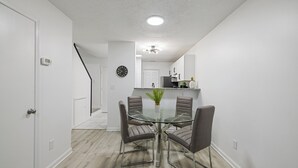 A modern kitchen with white cabinets, a built-in oven, and a microwave. - 13 Minutes from Downtown Raleigh  (Raleigh)