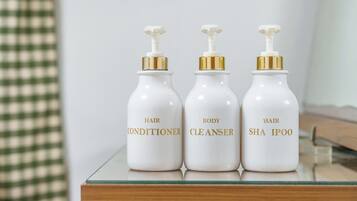 Three bottles of hair care products on a reflective surface.