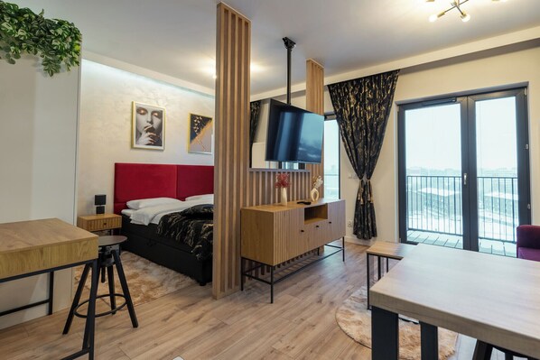Relax in a stylish room with a large bed, flat-screen TV, and city views from the balcony.