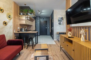 Relax in a welcoming space with a comfortable sofa, dining area, and large flat-screen TV.