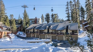 A multi-story building with a ski lift in the background. - Slopeside Retreat at Mammoth Mountain, Ski-in\Ski-out at Canyon Lodge (Mammoth Lakes)