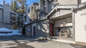 A residential building with a balcony, a red door, and a sign indicating private parking. - Slopeside Retreat at Mammoth Mountain, Ski-in\Ski-out at Canyon Lodge (Mammoth Lakes)