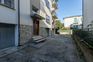 A residential building with a stone facade, a wooden door, and a balcony.