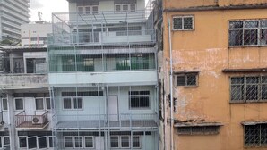 A multi-story building with balconies, air conditioning units, and a water tank. - MAXi MaMa Room (Bangkok)