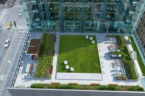 Relax in our rooftop garden, surrounded by lush plants and flowers, with seating areas to enjoy the city view.