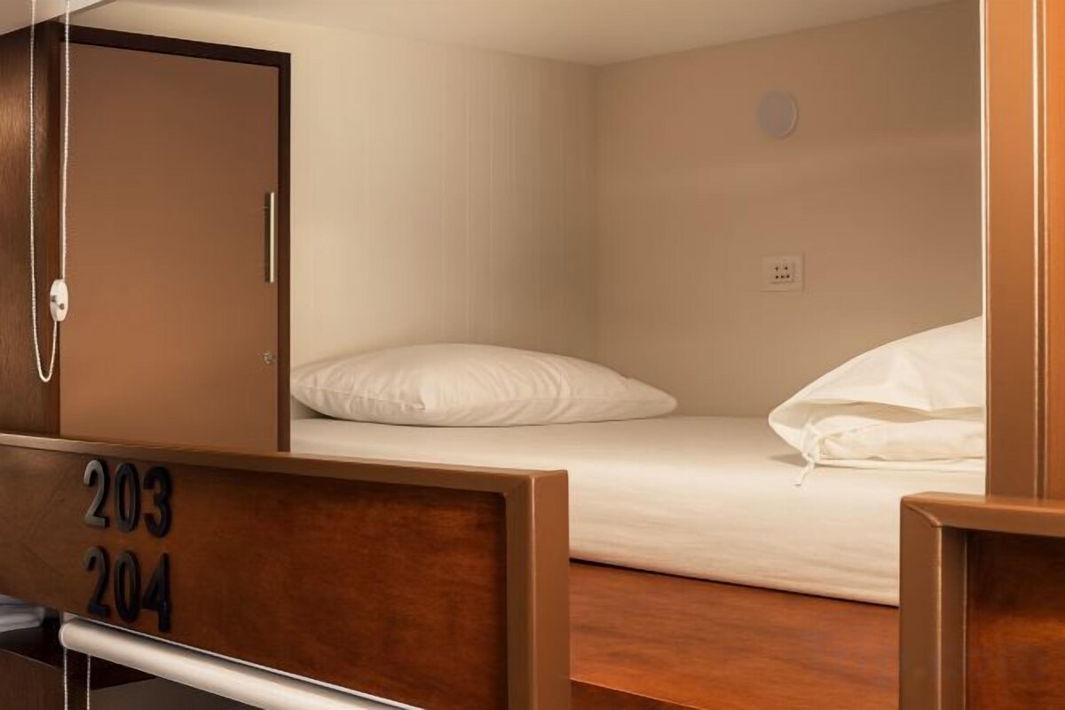 Premium bedding, desk, laptop workspace, soundproofing