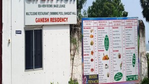A signboard for Hotel Tenach, listing amenities like a swimming pool, banquet hall, and a menu with various food and drink options. - Hotel Tenach (Puducherry)