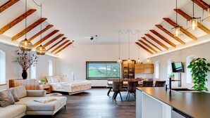 A modern interior with a dining area, kitchen, and living space. - Studio Apartment 'Außergewöhnliches Loft' with Mountain View and Wi-Fi (Senftenbach)