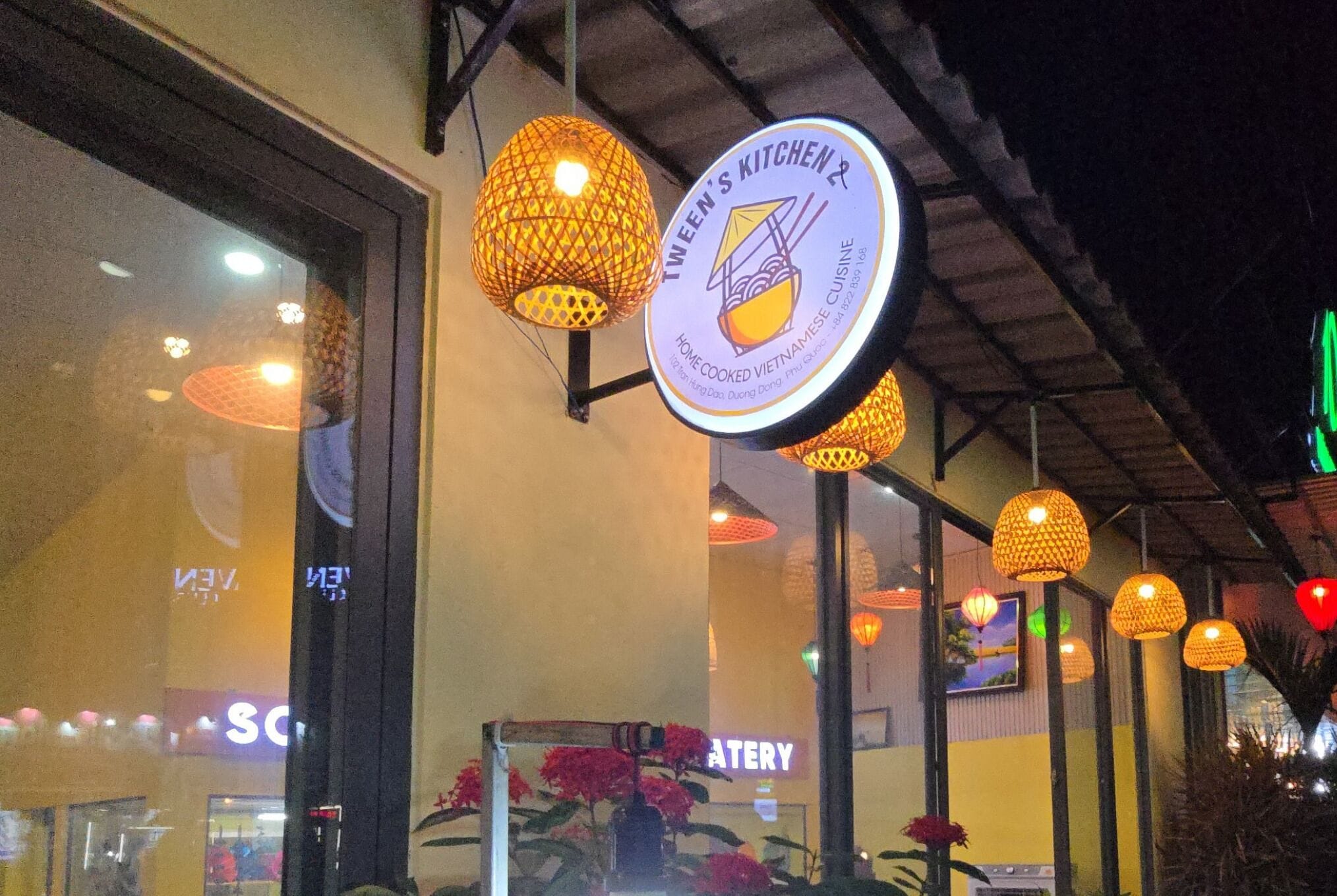 A restaurant with hanging spherical lights and a sign indicating it serves Vietnamese cuisine.