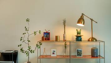 A shelf with various decorative items including a framed picture, a bottle, a small figurine, and a lamp.