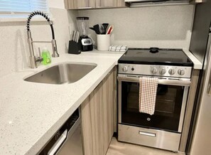 Fridge, coffee/tea maker, cookware/dishes/utensils