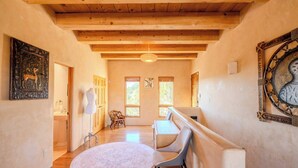 A hallway with wooden beams, a round rug, and a bench. - Amazing views, Stunning Sunny Interior (Santa Fe)