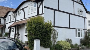 A traditional half-timbered house with white walls and dark timber framing. - Home from home - classic country cottage with all amenities in peaceful village
 (Andover)