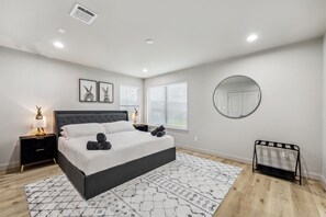 Spacious primary bedroom with king size bed.