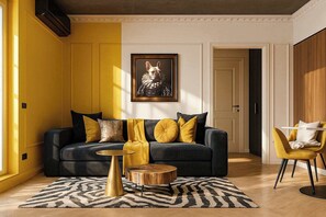 A living room with a dark sofa, yellow cushions, a round wooden coffee table, and a zebra-patterned rug.
