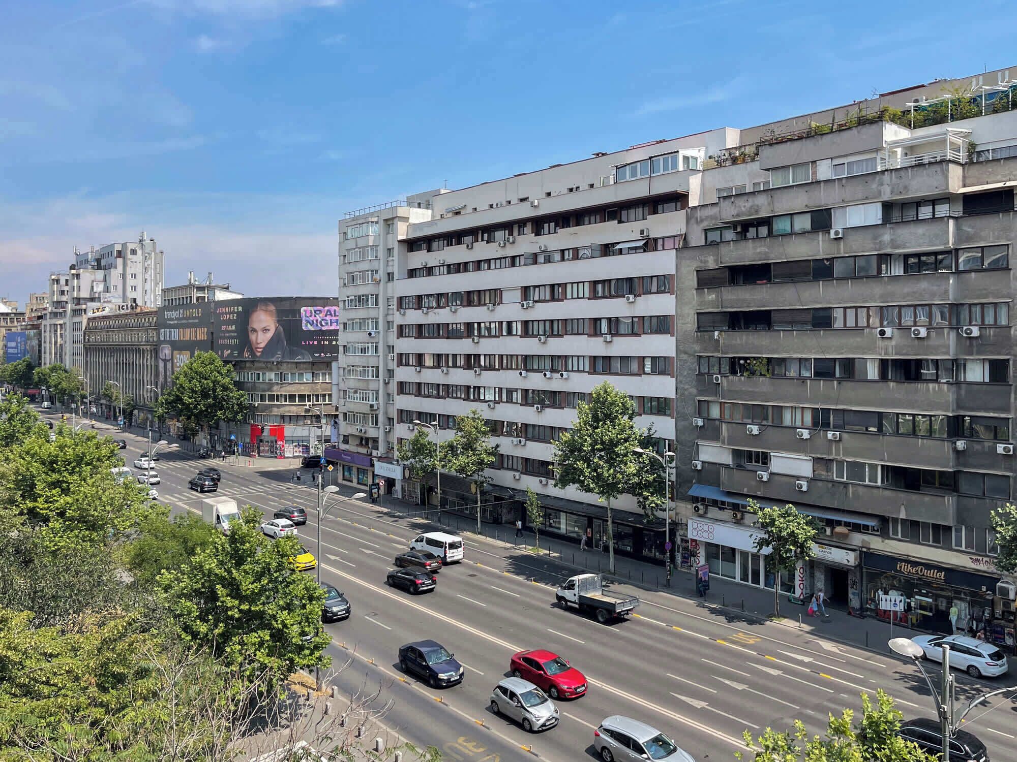 A multi-story building with a modern architectural design, featuring a mix of residential and commercial spaces.
