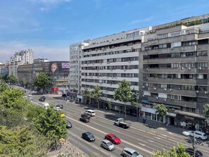A multi-story building with a modern architectural design, featuring a mix of residential and commercial spaces.