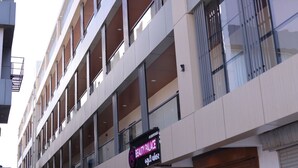 A multi-story building with a sign for "Beauty Palace" on the ground floor.
