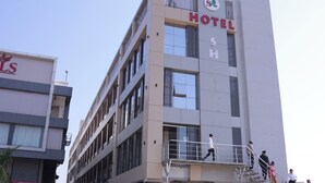 A multi-story hotel building with a sign indicating it is a hotel.
