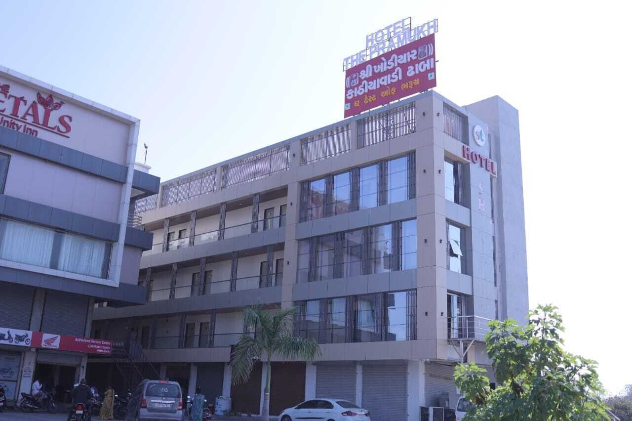 A multi-story hotel with a signboard for 'Hotel' and 'Unity Inn' visible.