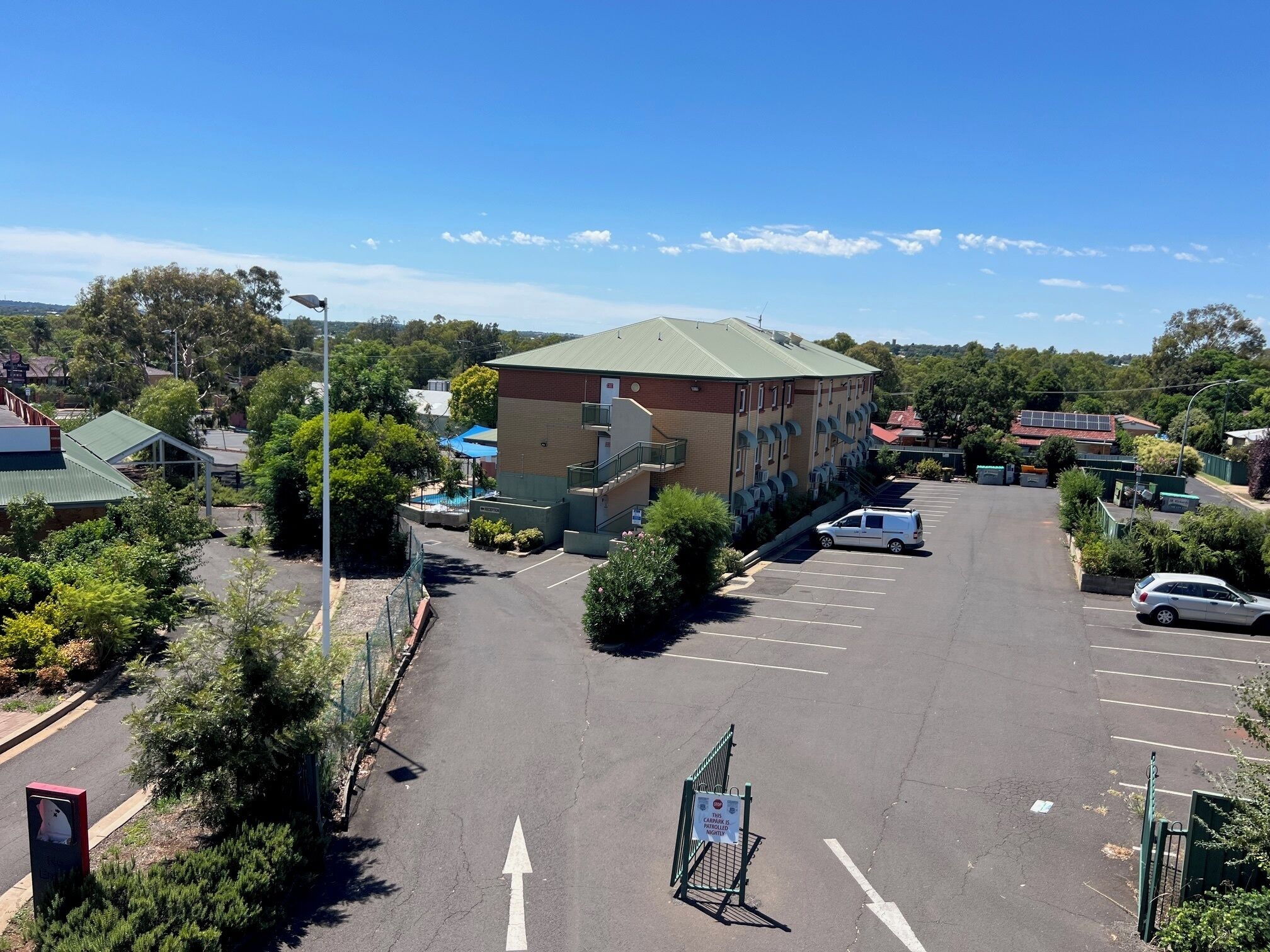 A parking lot with a building in the background.