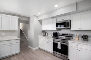 Coffee/tea maker, fridge, microwave, oven