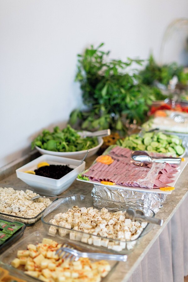 A buffet table with various food items including salads, meats, and cheeses. - Aqua Nina Resort Hotel (Burhaniye)