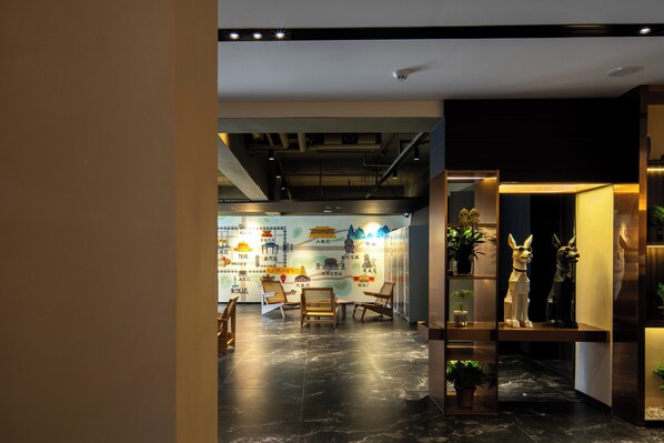 A modern interior with a dining area, seating, and decorative elements.