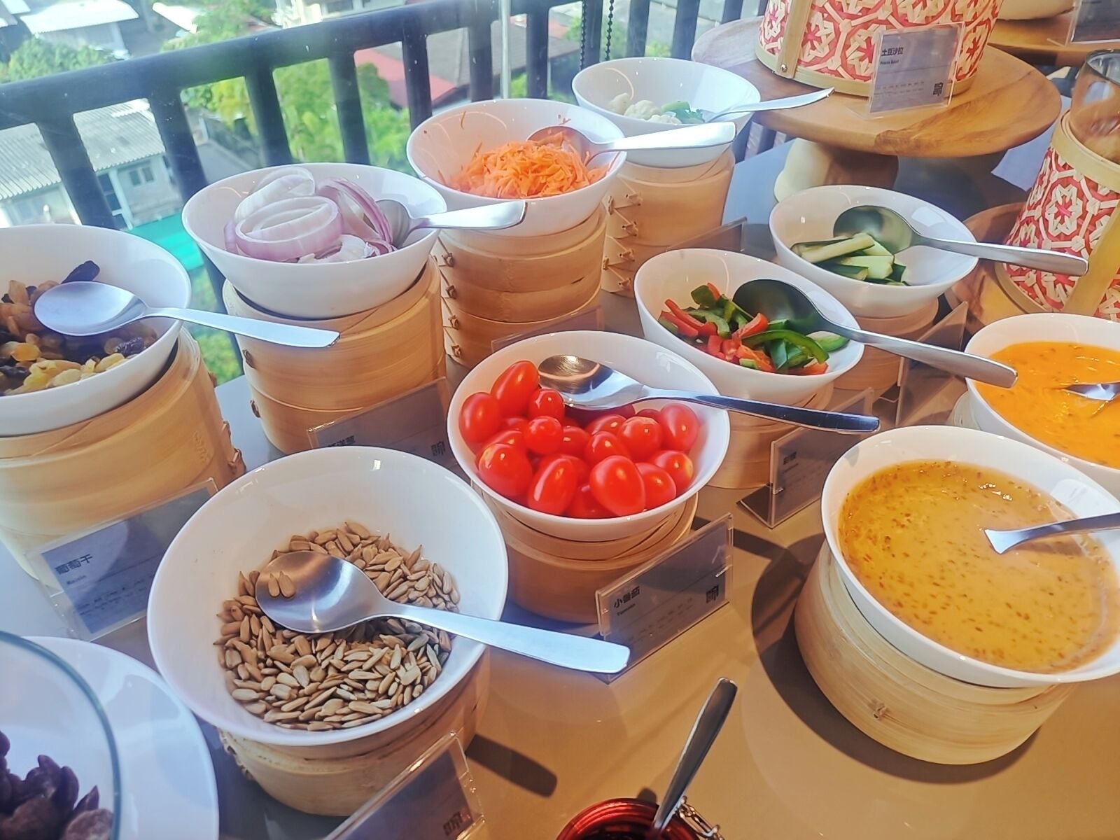 A buffet table with various food items and utensils.