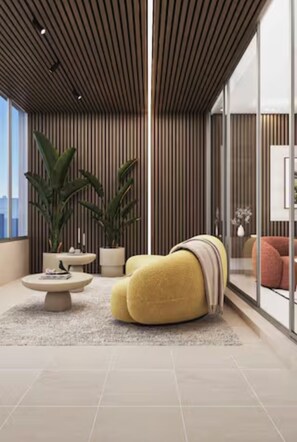 Relax in a stylish space with a plush sofa, round coffee table, and comfortable seating areas.