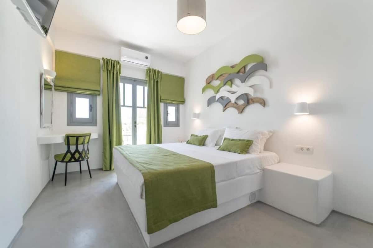 A modern bedroom with a bed, bedside table, and a chair.
