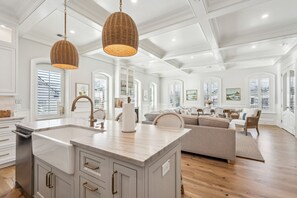 A spacious kitchen with a large island, white cabinetry, and pendant lighting. - New Build - Steps to King Street (Charleston)