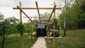 A rustic wooden structure with a gravel path leading to a black building labeled "PURPLEWISTERM". - PurpleVague (Runcu)
