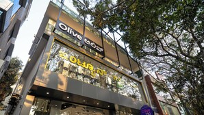 Un edificio moderno con un'ampia vetrina e insegna con scritto "Olive Zip".