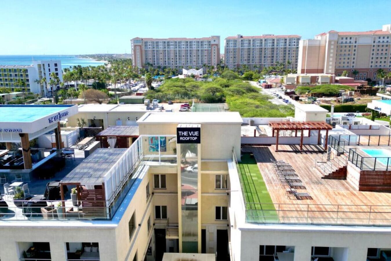 Eine Dachterrasse mit einem Schild für 'The Vue Rooftop' und einem Pool.