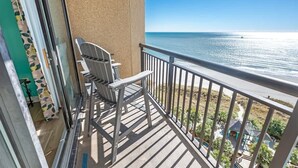 A balcony with a view of the ocean, a chair, and a railing. - Direct Oceanfront 1 BR, Warm Swimming Pools,Views! (North Myrtle Beach)