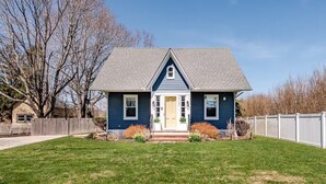 A single-story house with a gabled roof, a front porch, and a well-maintained lawn.