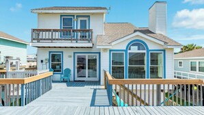 A two-story house with a wooden deck, a balcony, and a garage. - Second Wind Bay House - Fish, Float, Fun! (Freeport)
