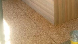 A reception area with a wooden counter, a door, and a tiled floor. - White House Lounge & Accommodation  (Eldoret)
