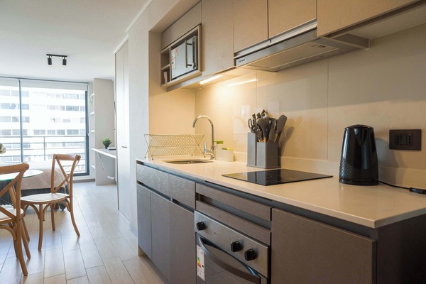 Enjoy cooking in this modern, fully-equipped kitchen with natural light and stylish dining space.