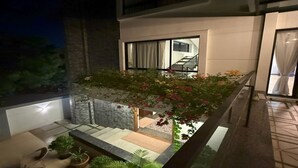 A modern building with a balcony, a staircase, and a small garden area. - The Serene Shores - Luxury Private Villa (Vanur)