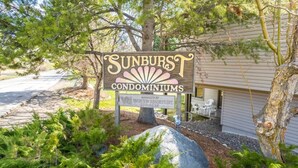 A sign for Sunburst Condominiums with a contact number and a note that it is managed by Vacation Resorts International.